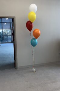 Colorful latex helium balloon bouquet with five balloons for party decoration.